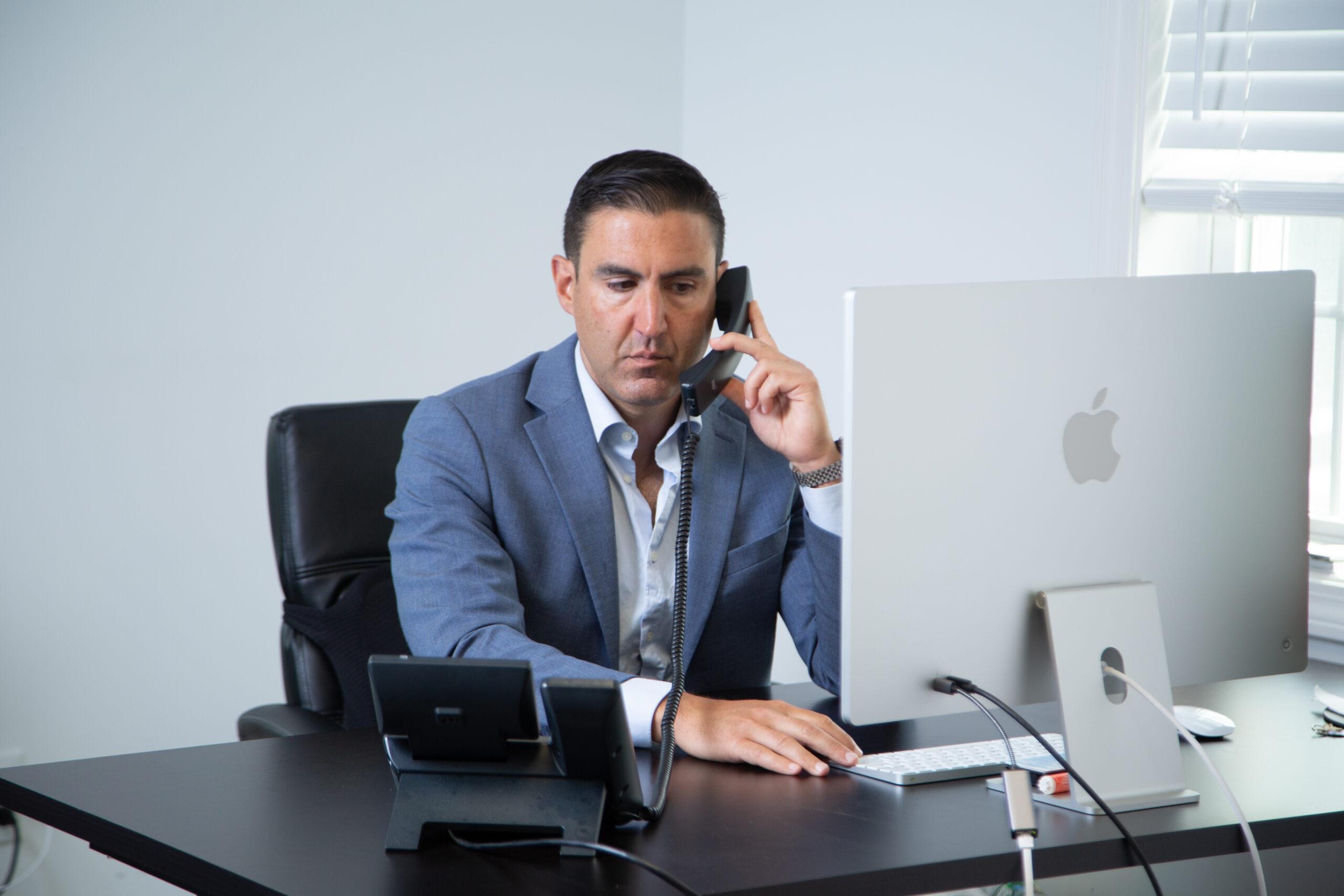 an attorney on the phone at their desk