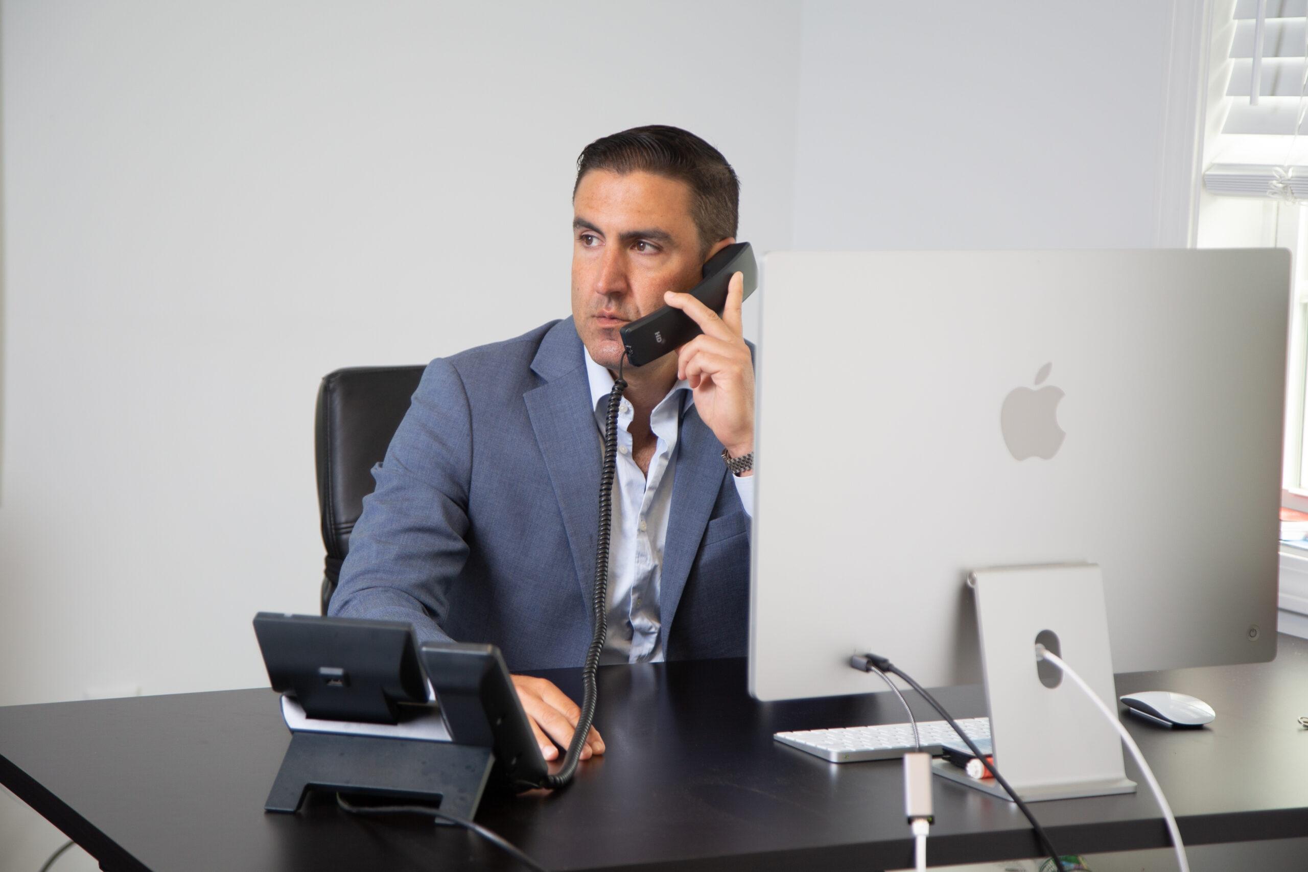 an attorney talking on the phone at his desk