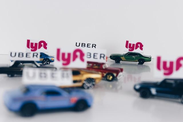 toy cars with Uber and Lyft signs attached to them