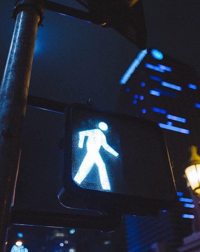 a crosswalk signal showing the walk sign